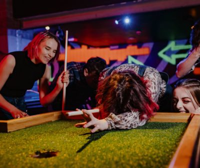Four people having fun playing crazy pool at Roxy Ball Room, Merrion Street, Leeds