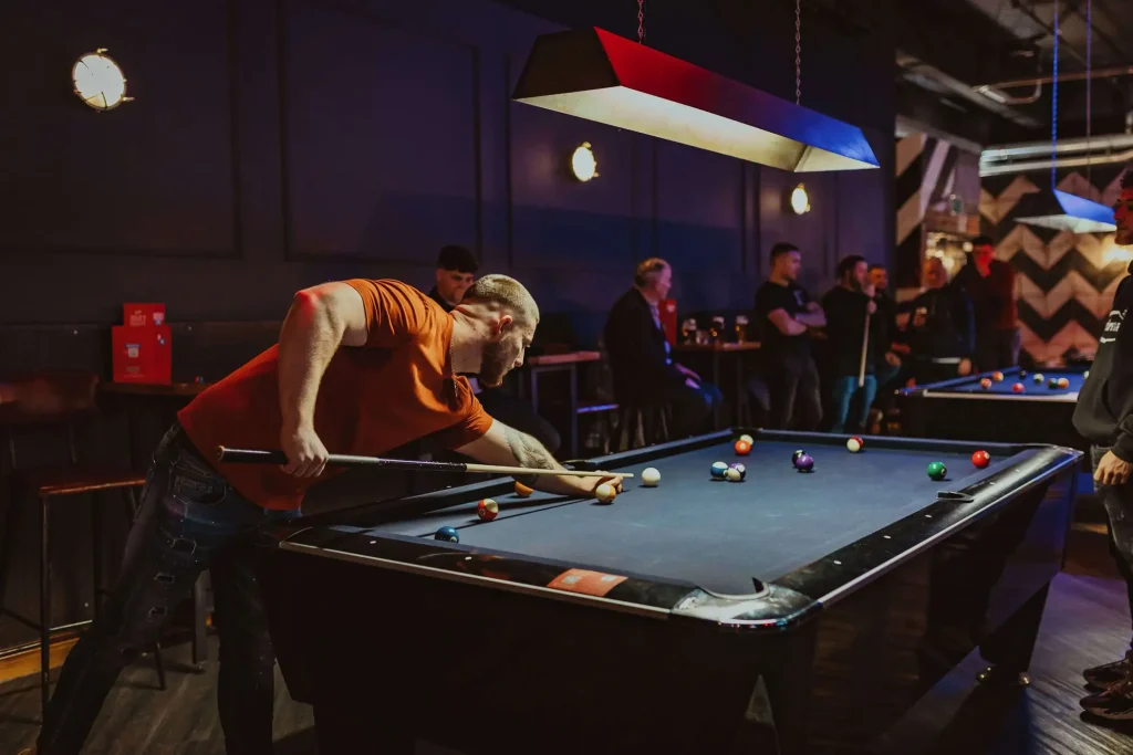 Young people playing pool at Roxy Ball Room, Arndale, Manchester
