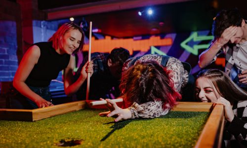 Four people having fun playing crazy pool at Roxy Ball Room, Merrion Street, Leeds